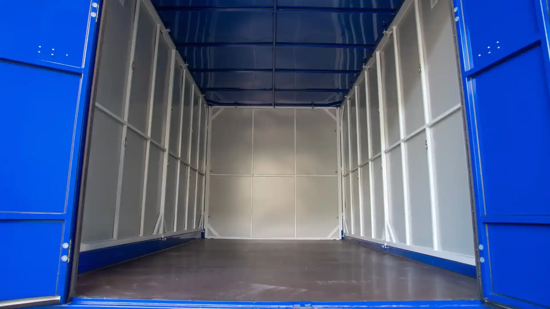 Customer carrying boxes beside an open BlueBox container